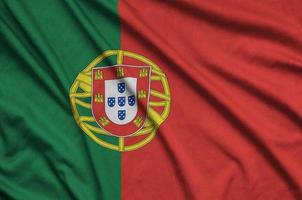 Portugal flag is depicted on a sports cloth fabric with many folds. Sport team banner photo