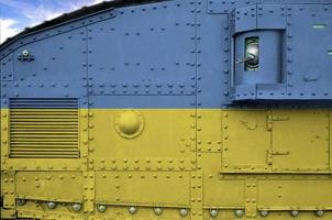 Ukraine flag depicted on side part of military armored tank closeup. Army forces conceptual background photo