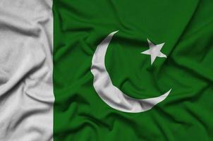 Pakistan flag is depicted on a sports cloth fabric with many folds. Sport team banner photo