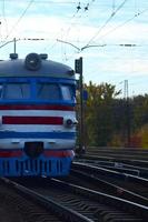 Old soviet electric train with outdated design moving by rail photo