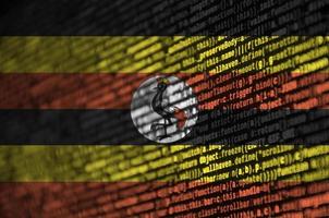 Uganda flag is depicted on the screen with the program code. The concept of modern technology and site development photo