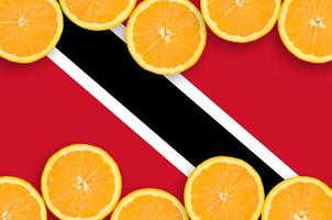 Trinidad and Tobago flag in citrus fruit slices horizontal frame photo