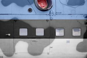 Estonia flag depicted on side part of military armored helicopter closeup. Army forces aircraft conceptual background photo