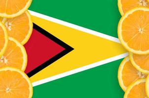 Guyana flag in citrus fruit slices vertical frame photo