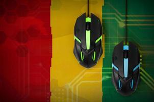 Guinea flag and two mice with backlight. Online cooperative games. Cyber sport team photo