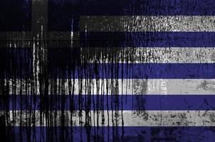 Greece flag depicted in paint colors on old and dirty oil barrel wall closeup. Textured banner on rough background photo