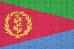 Eritrea flag is depicted on a folded puzzle photo