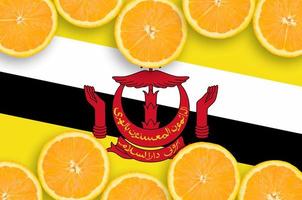 Brunei Darussalam flag in citrus fruit slices horizontal frame photo