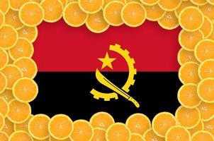 Angola flag in fresh citrus fruit slices frame photo