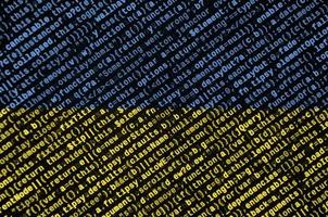 Ukraine flag is depicted on the screen with the program code. The concept of modern technology and site development photo