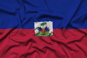 Haiti flag is depicted on a sports cloth fabric with many folds. Sport team banner photo