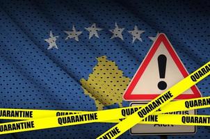 Kosovo flag and Covid-19 quarantine yellow tape. Coronavirus or 2019-nCov virus photo