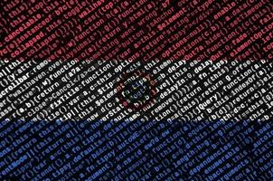 Paraguay flag is depicted on the screen with the program code. The concept of modern technology and site development photo