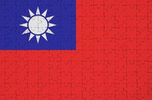 Taiwan flag is depicted on a folded puzzle photo