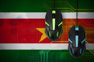 Suriname flag and two mice with backlight. Online cooperative games. Cyber sport team photo