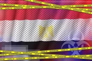 Egypt flag and Covid-19 quarantine yellow tape. Coronavirus or 2019-nCov virus concept photo