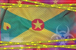 Grenada flag and Covid-19 quarantine yellow tape. Coronavirus or 2019-nCov virus concept photo