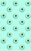 Many small plastic donuts lies on a pastel colorful background. Flat lay minimal pattern. Top view photo