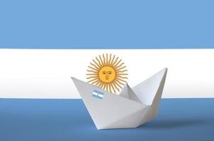 Argentina flag depicted on paper origami ship closeup. Handmade arts concept photo