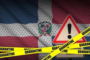 Dominican Republic flag and Covid-19 quarantine yellow tape. Coronavirus or 2019-nCov virus photo