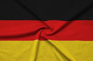Germany flag is depicted on a sports cloth fabric with many folds. Sport team banner photo