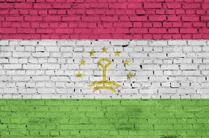 Tajikistan flag is painted onto an old brick wall photo
