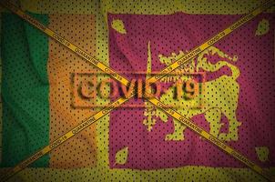 Sri Lanka flag and Covid-19 stamp with orange quarantine border tape cross. Coronavirus or 2019-nCov virus concept photo