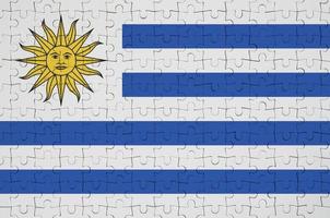 Uruguay flag is depicted on a folded puzzle photo