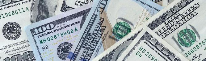 Abstract backdrop with many hundred dollar bills close up photo