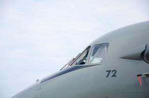 Cabin of armoured military aircraft close up against blue sky photo