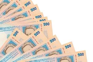 200 Ukrainian hryvnias bills lies isolated on white background with copy space stacked in fan close up photo