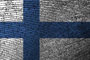 Finland flag is depicted on the screen with the program code. The concept of modern technology and site development photo