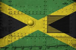 Jamaica flag depicted on side part of military armored tank closeup. Army forces conceptual background photo