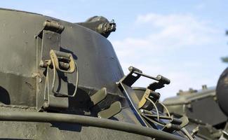 Tower of an armored personnel carrier or tank. Heavy weapons of war, sky background. Army equipment for combat and defense. Cannon tower. Details of military equipment. Close-up. photo