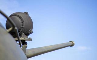 Tower of an armored personnel carrier or tank. Heavy weapons of war, sky background. Army equipment for combat and defense. Cannon tower. Details of military equipment. Close-up. photo