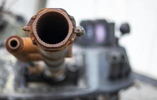 Tank gun, barrel muzzle of a military army close-up. Broken burnt tank. Barrel of a tank gun, selective focus. Destroyed and burned tank, military equipment in the vicinity of Kyiv. War in Ukraine. photo