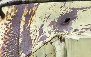 Russian combat vehicle, with holes in the armor. Destroyed military armored vehicles, disabled, blown up and destroyed. Armor metal background with bullet holes. Hole from cumulative penetration. photo