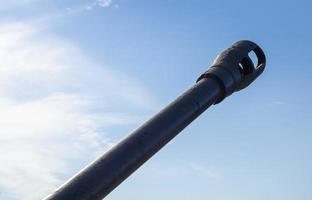 Soviet light amphibious tank PT-76. Object 740. Tank barrel, barrel against the sky. Tank gun. muzzle or flame arrester close-up. photo