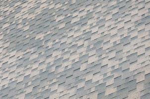 Background mosaic texture of flat roof tiles with bituminous coating photo