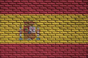 Spain flag is painted onto an old brick wall photo
