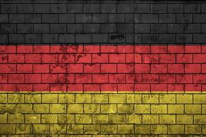 Germany flag is painted onto an old brick wall photo