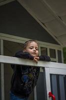 A child is playing on the playground in a children's house. Presents himself as the owner of the house. Portrait of a child photo