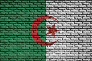 Algeria flag is painted onto an old brick wall photo