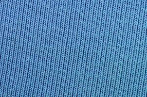 The texture of the fabric in blue color. Material for making shirts and blouses photo