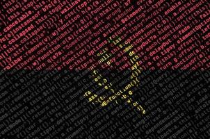 Angola flag is depicted on the screen with the program code. The concept of modern technology and site development photo