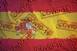 Spain flag and many red Covid-19 stamps. Coronavirus or 2019-nCov virus concept photo