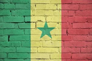 Senegal flag is painted onto an old brick wall photo