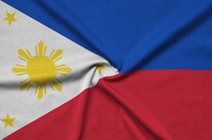 Philippines flag is depicted on a sports cloth fabric with many folds. Sport team banner photo