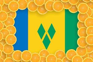 Saint Vincent and the Grenadines flag in fresh citrus fruit slices frame photo