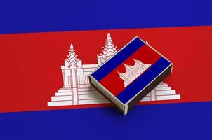Cambodia flag is pictured on a matchbox that lies on a large flag photo